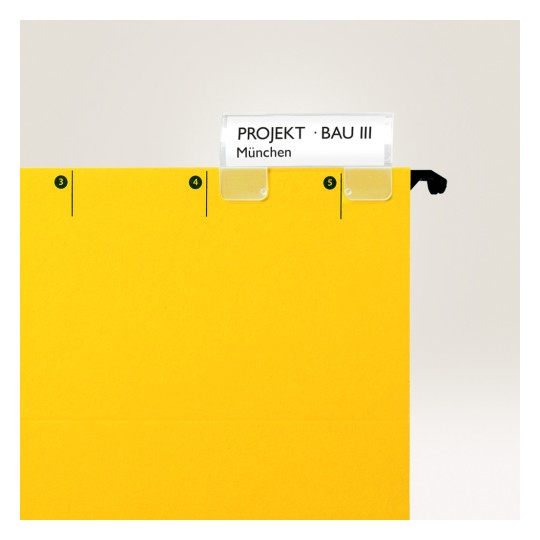 Slika prikazuje svijetlo žutu mapu s držačem za etiketu na kojoj piše 'PROJEKT · BAU III' i 'München'. Mapa ima brojčane oznake s bočne strane.
