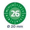Slika prikazuje kružni brojčanik sa zelenom pozadinom, na kojem se u središtu nalazi broj 26. Oko središta su brojevi od 1 do 12. Ispod brojčanika nalazi se oznaka koja pokazuje promjer od 20 mm.